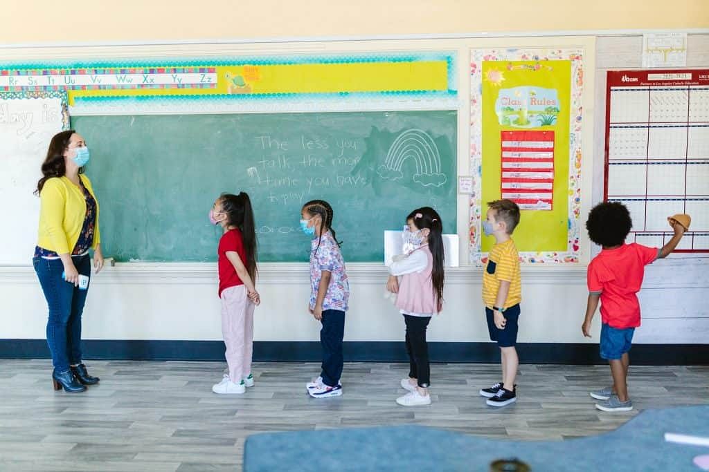 Children Lined up in a classroom with their teacher